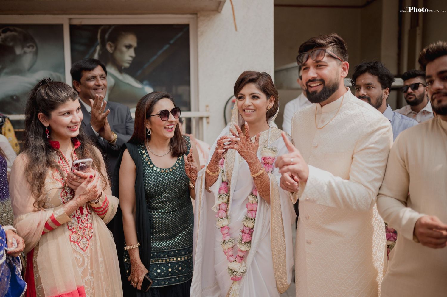 Wedding celebration with guests in colorful attire enjoying the festivities.