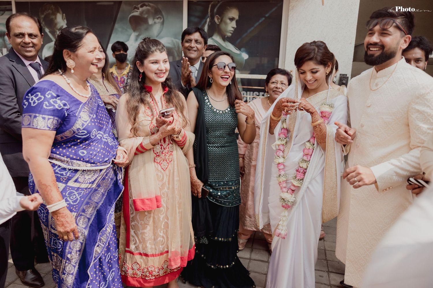 Wedding guests in vibrant traditional attire celebrating during the ceremony.