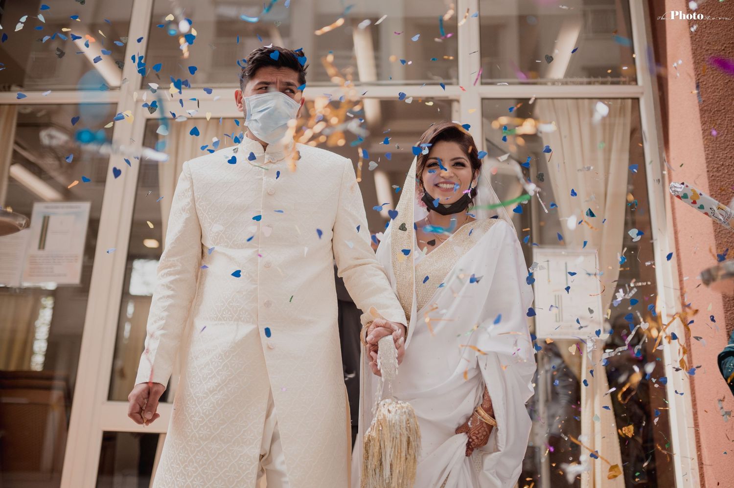 Celebratory moment with confetti falling during an outdoor wedding ceremony.