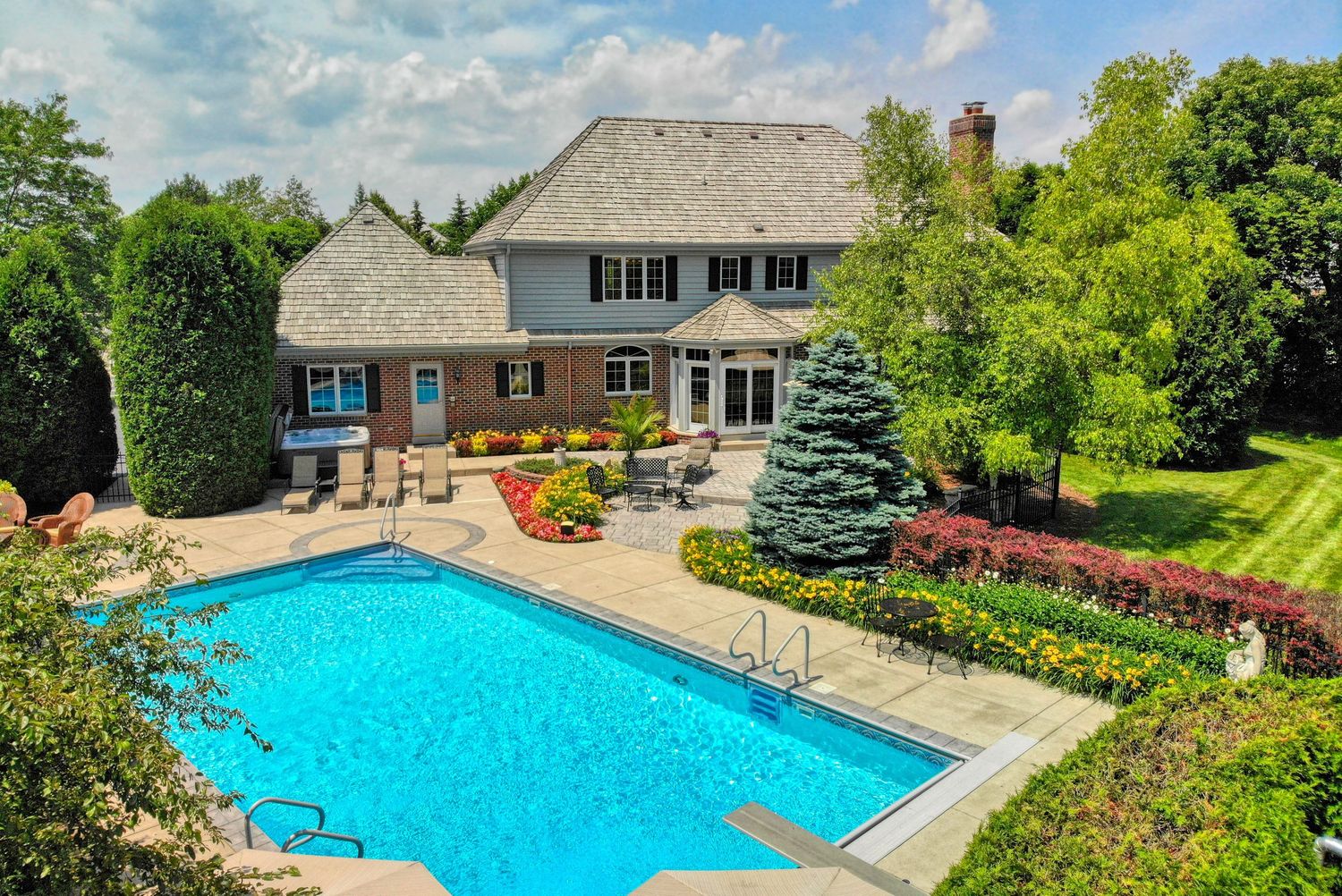 Aerial drone photo of a luxury home with backyard swimming pool, Wisconsin