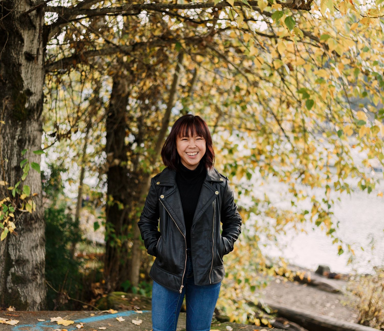 graduate student smiles in cathedral park, portland, oregon