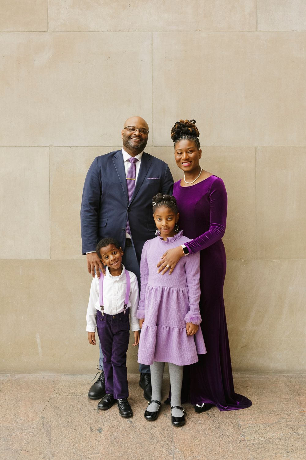 Unified family portrait against The Met's stunning marble backdrop, expertly photographed by Paula Ortiz in NYC