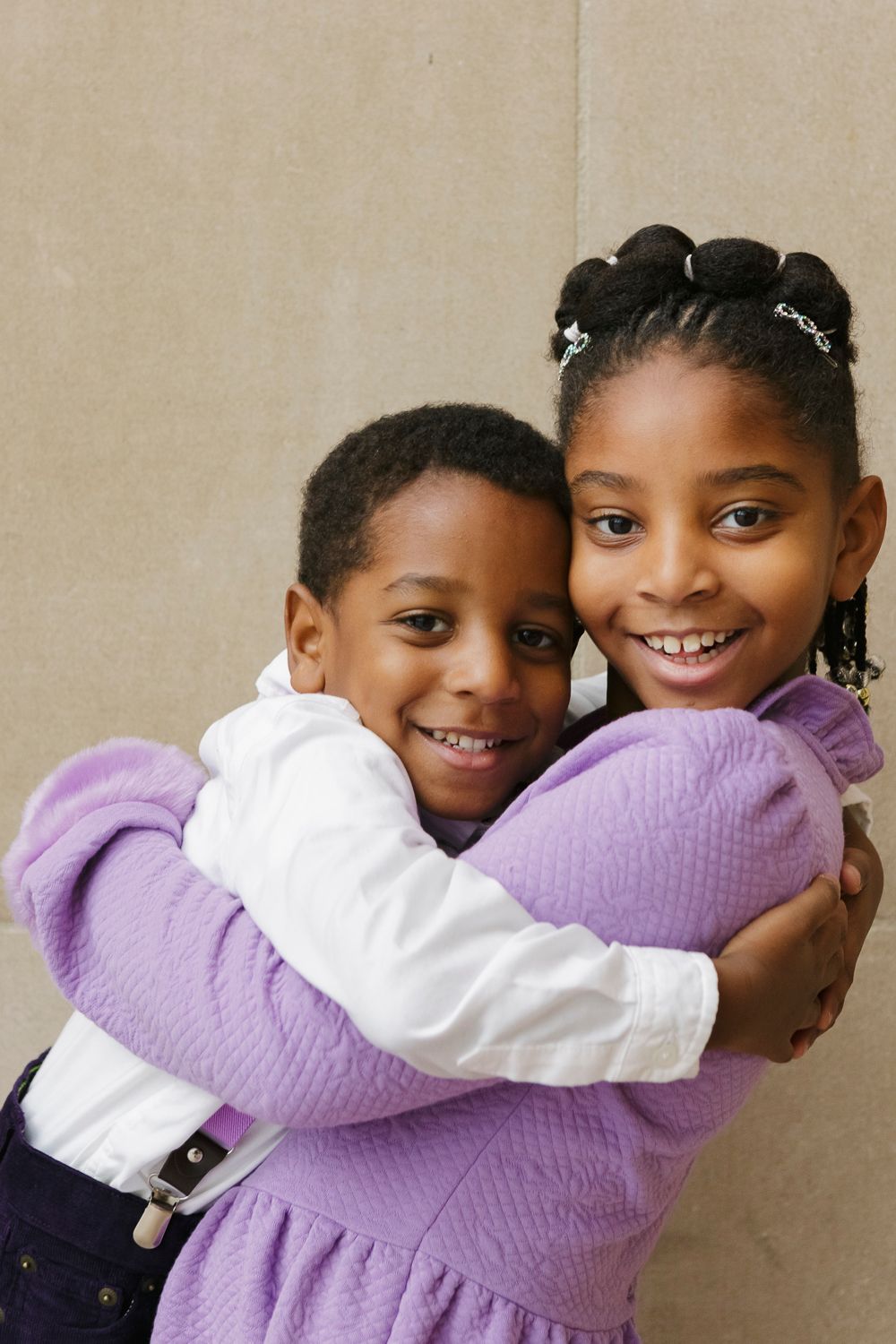 Big sister and little brother share smiles and a loving embrace, beautifully photographed by Paula Ortiz during a family