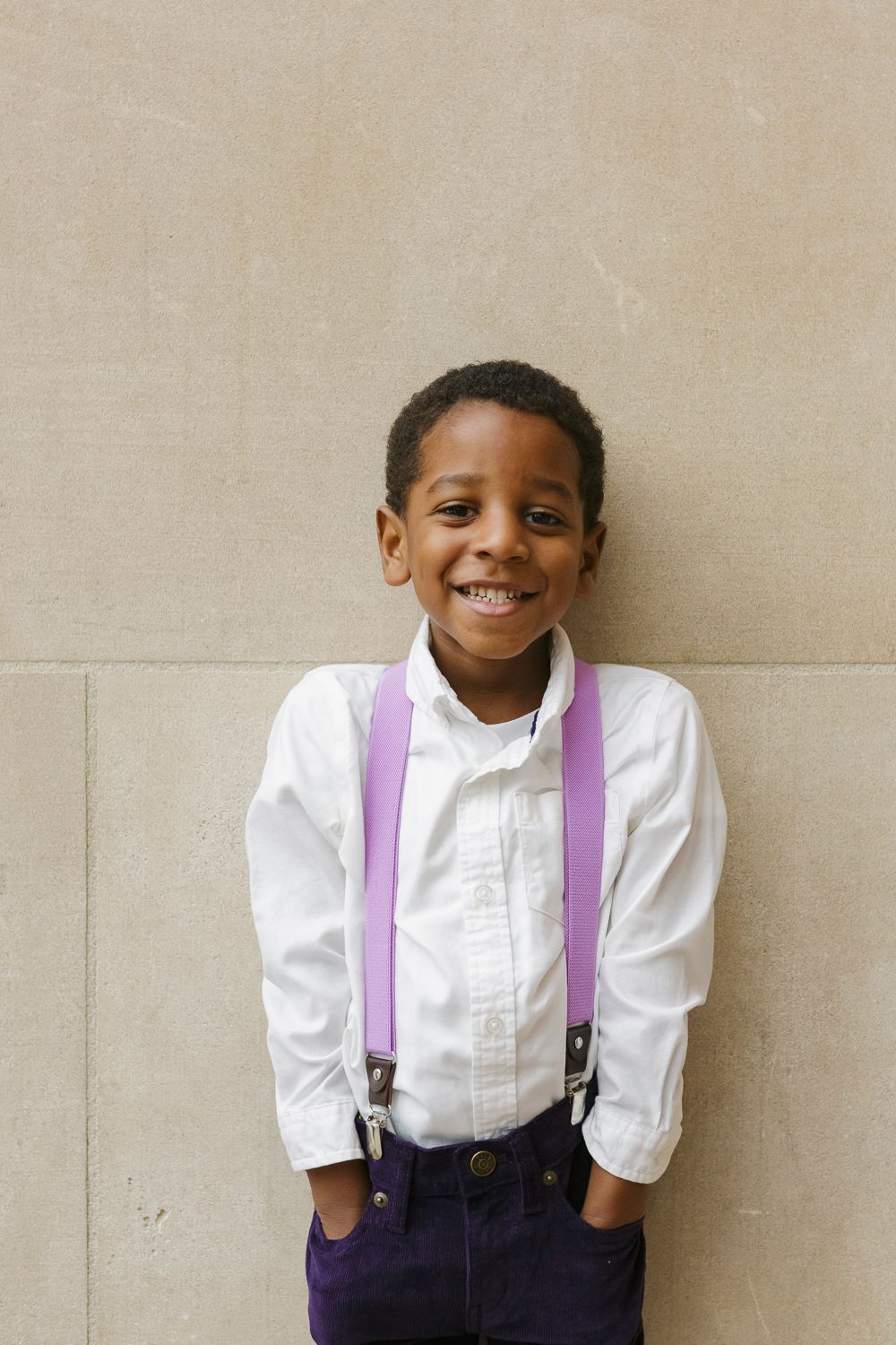 Joyful little brother captured in a candid moment by Paula Ortiz during a family session in NYC
