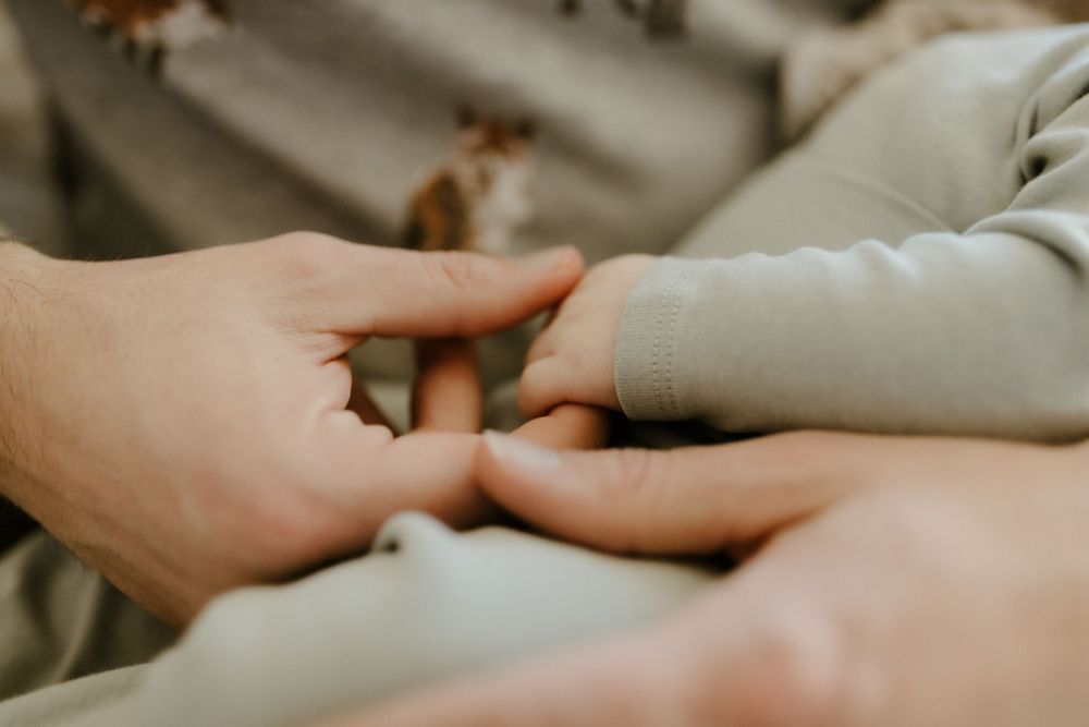 Candid family portrait in Joplin, Missouri captured in natural light by Modern Moods Imagery, showing genuine connection and movement.