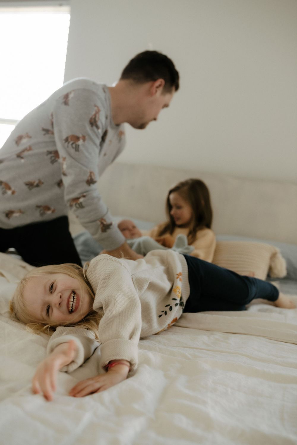 Candid family portrait in Joplin, Missouri captured in natural light by Modern Moods Imagery, showing genuine connection and movement.