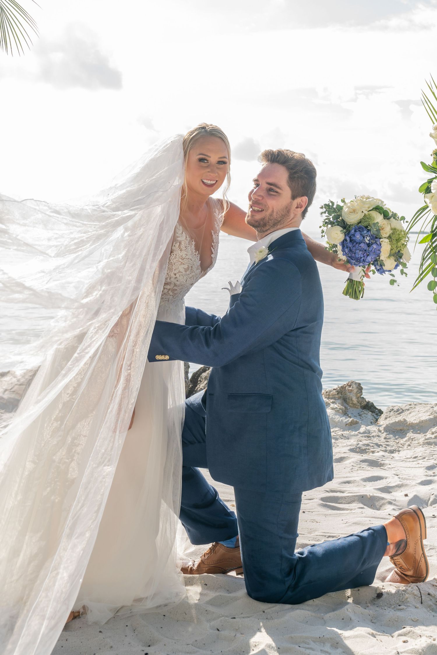 Scenic beach wedding ceremony photos with couple by ocean.