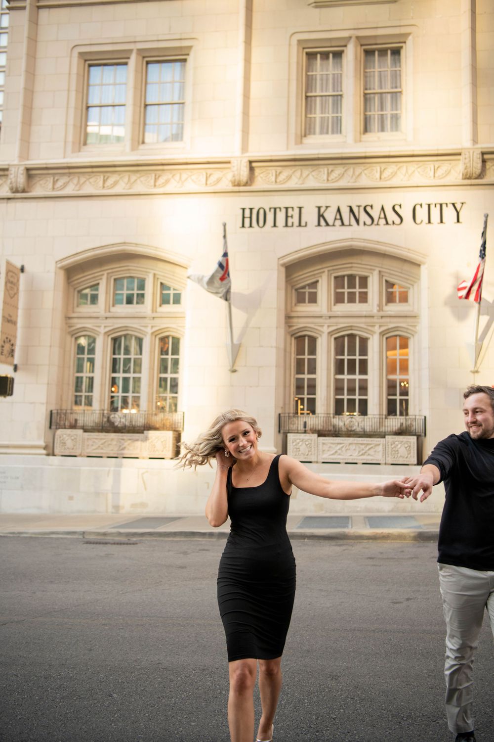 A playful moment outside the historic Hotel Kansas City building.