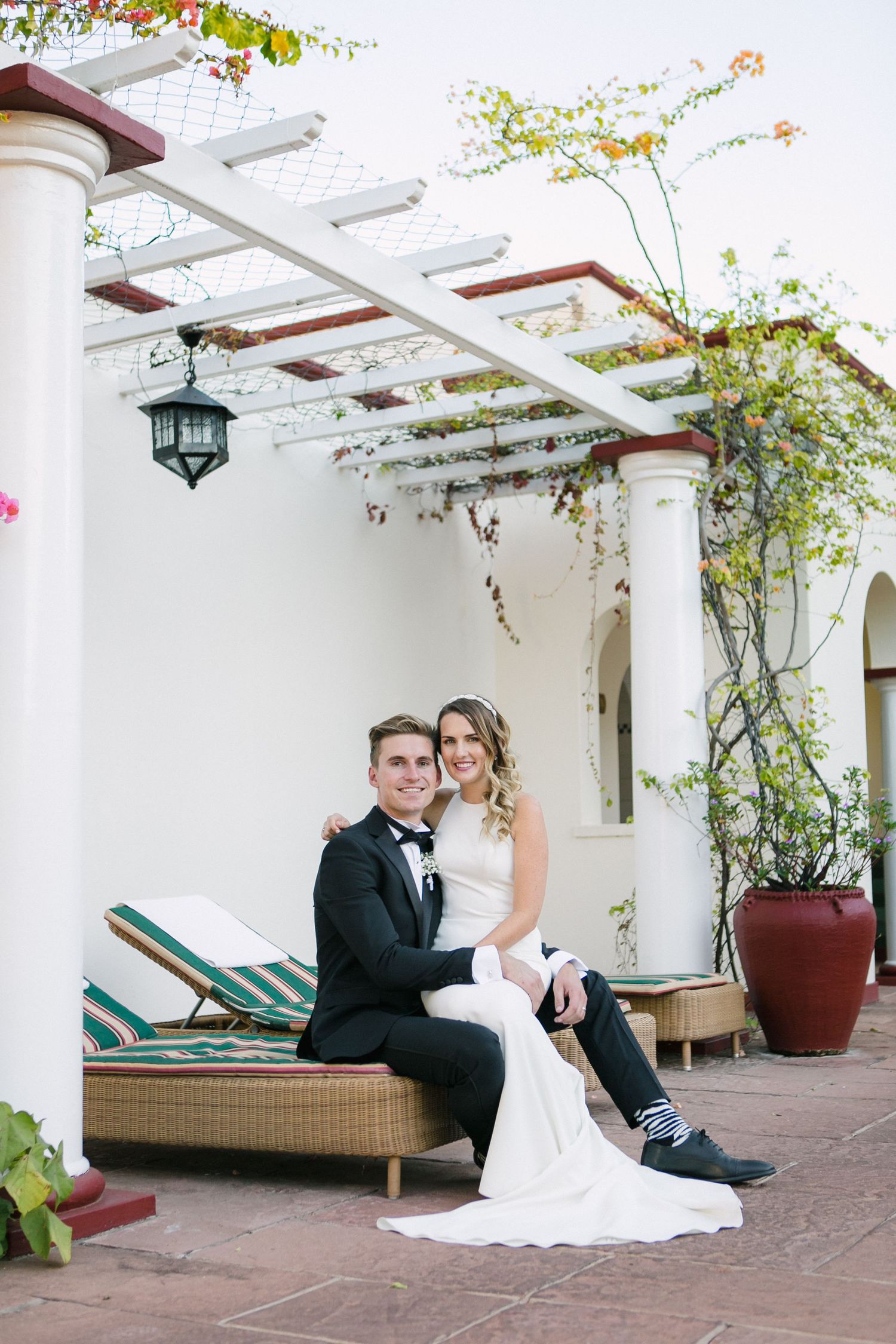 A wedding couple sitting at the swimming pool at the Victoria Falls Hotel in Zimbabwe.