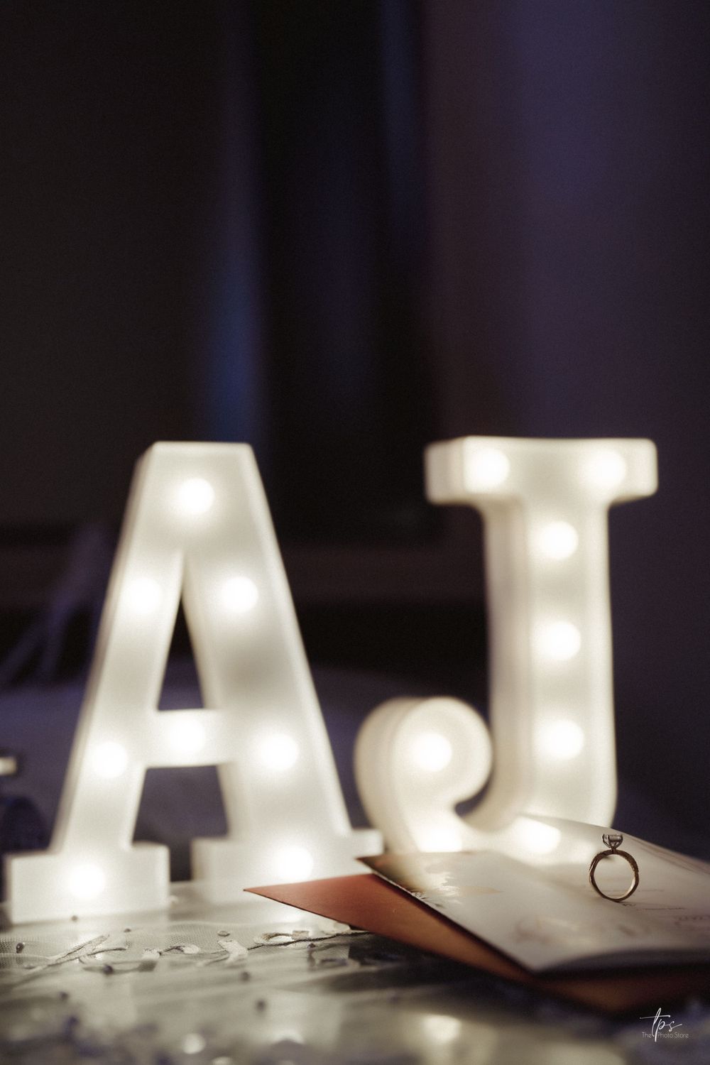 Illuminated marquee letters creating romantic lighting at wedding reception.