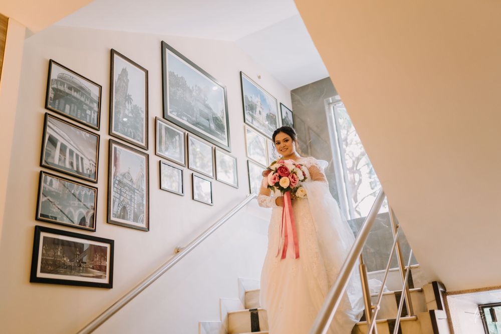 Wedding venue hallway decorated with framed artwork and soft natural lighting.