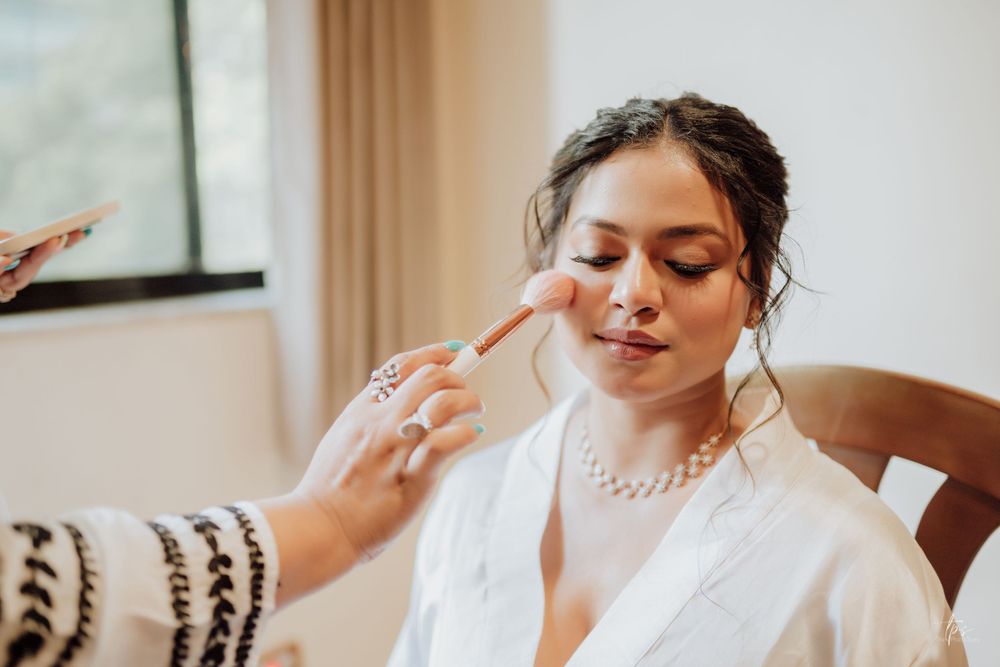 Bride getting ready on her wedding day with elegant makeup and hair styling.