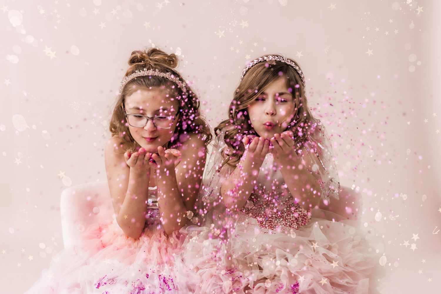 two girls blowing glitter little girl photoshoot