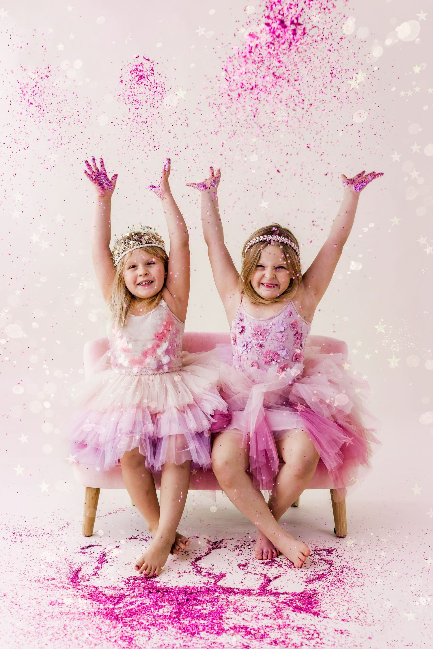 two girls throwing glitter in the air