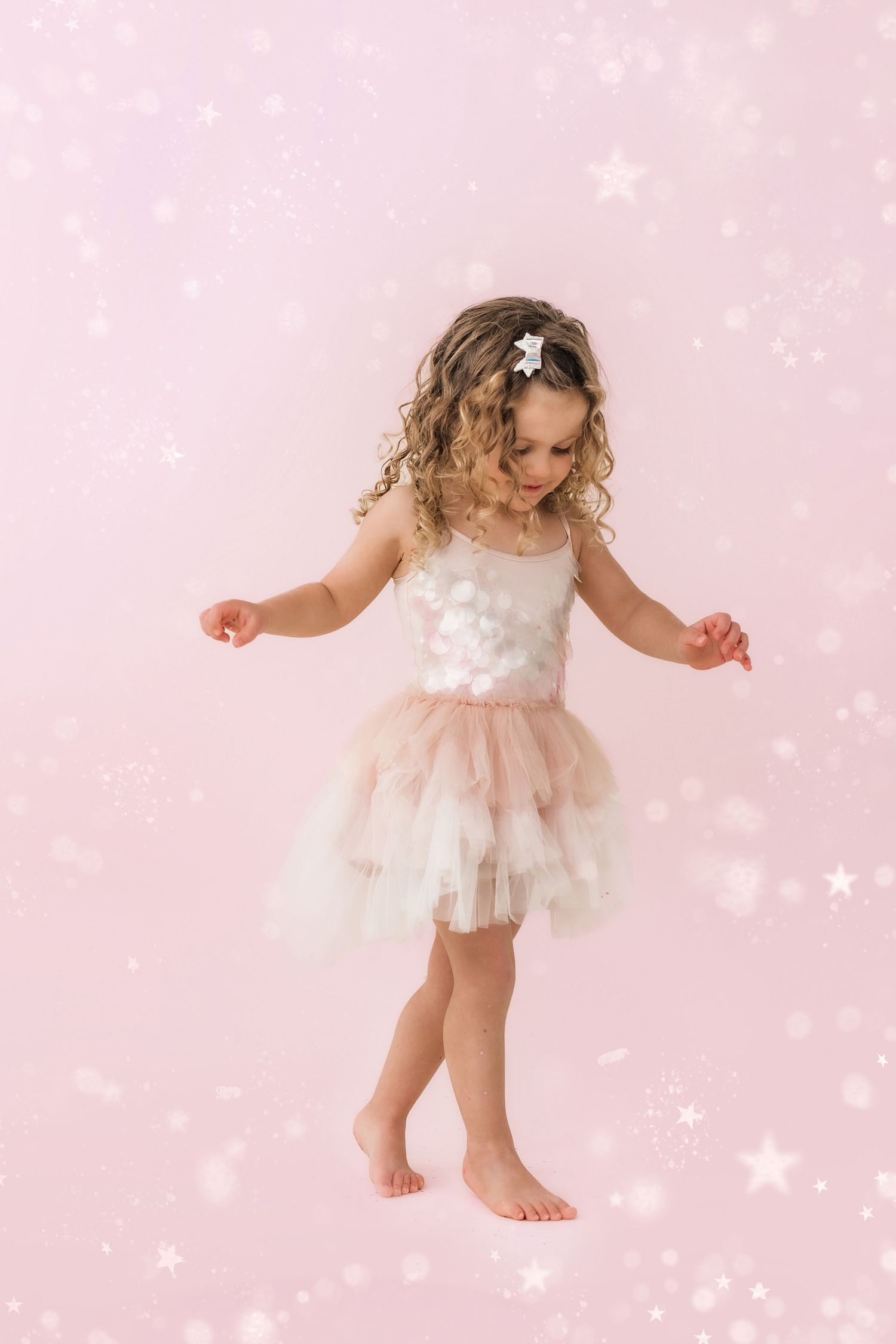 little girl dancing with glitter background