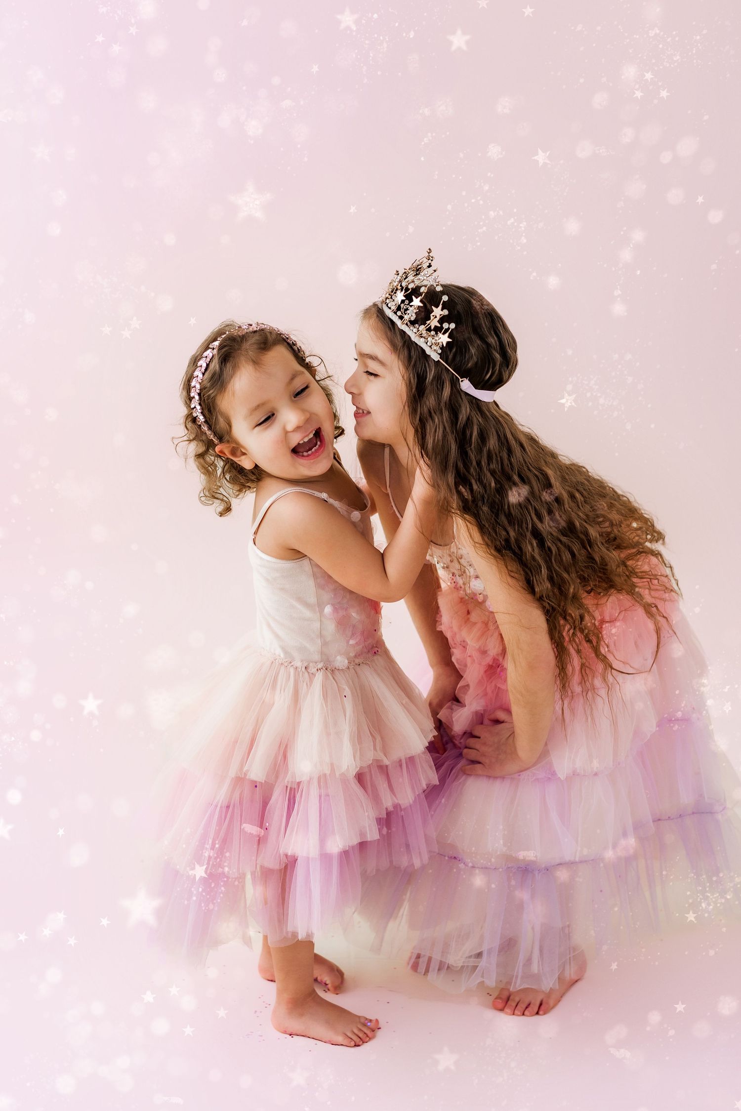 two sisters laughing and having fun with glitter