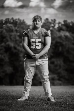 strong, piercing and masculine senior portrait showcasing this young man's love of football