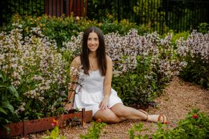 Sitting in a field of white flowers, this senior portrait is beautiful