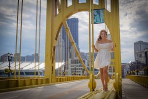 Featuring a vibrant yellow bridge in Pittburgh, PA this girl stands confidently on the metal bridge