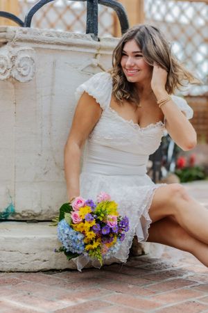 Feminine and classy, this sitting pose on brick steps features a girl laughing