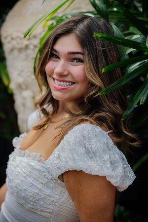 A stunning headshot of a girl framed by vibrant green leans
