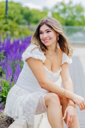 Beautiful stunning senior portrait of a girl looking off camera. Captures youth and vibrancy. Flowers frame her