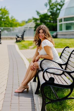 A classic pose on an iron bench, this girl's hair blowing widely is the perfect candid photo