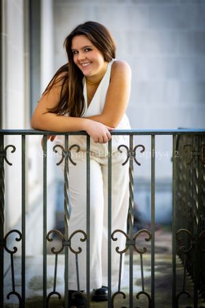 Using an iron gate, this girl leans cooly