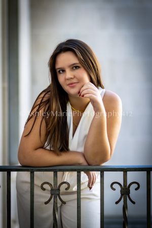 Excitement and youth are captured in this thoughtful pose for a senior portrait.