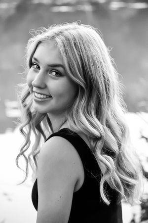 Classic black and white senior portrait of a girl glancing over her shoulder