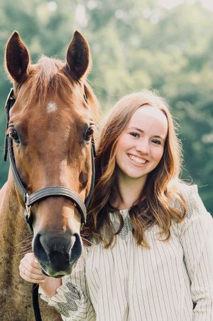 A senior portrait features a girl and her horse