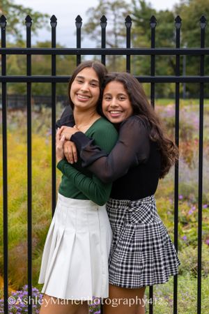 Two sisters hug and laugh together