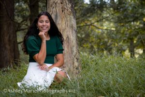 This image is perfect.  A girl sits in a forest, appears to contemplate the meaning of life while looking chic