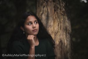 Dark and moody, this girl delicately holds her chin in her fingertips and shows off her beautiful profile