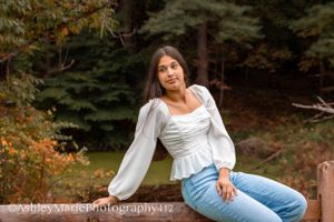Feminine and classy, this sitting pose on a wooden fence is a guaranteed beautiful image
