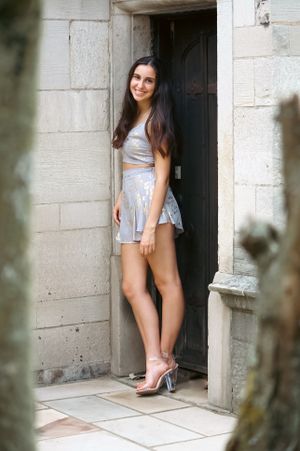 Nothing by attitude in this senior portrait of a girl posed against a wooden door.