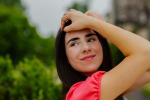 A stylish senior portrait of a girl framing her face