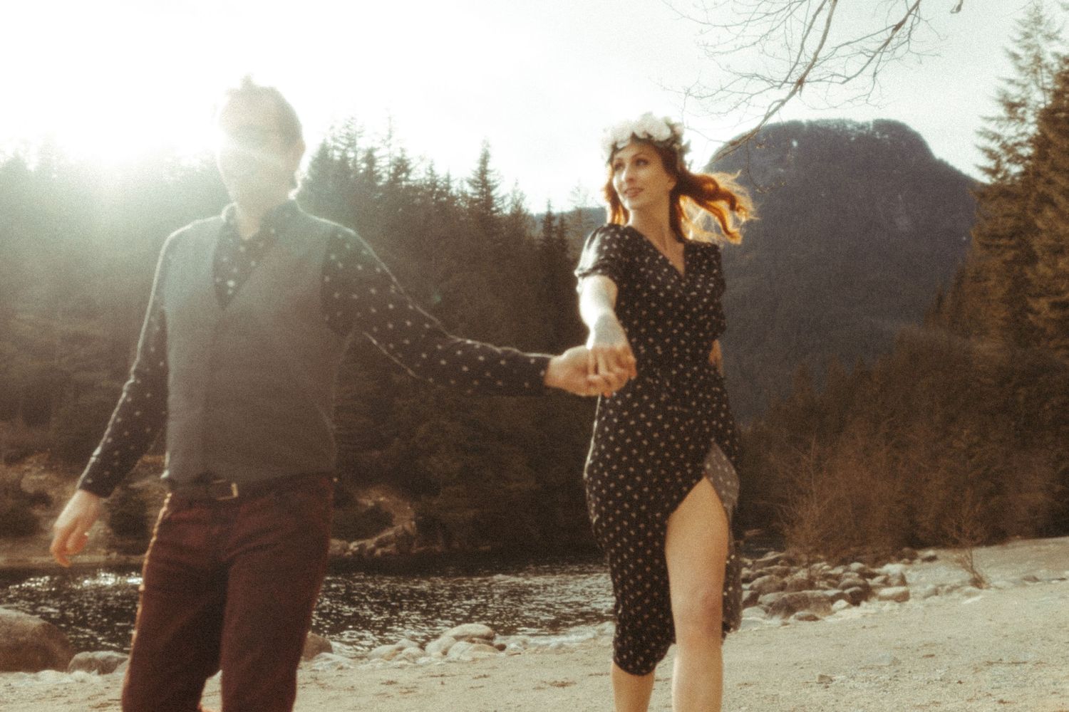 Couple running for engagement photos at Golden Ears Provincial Park