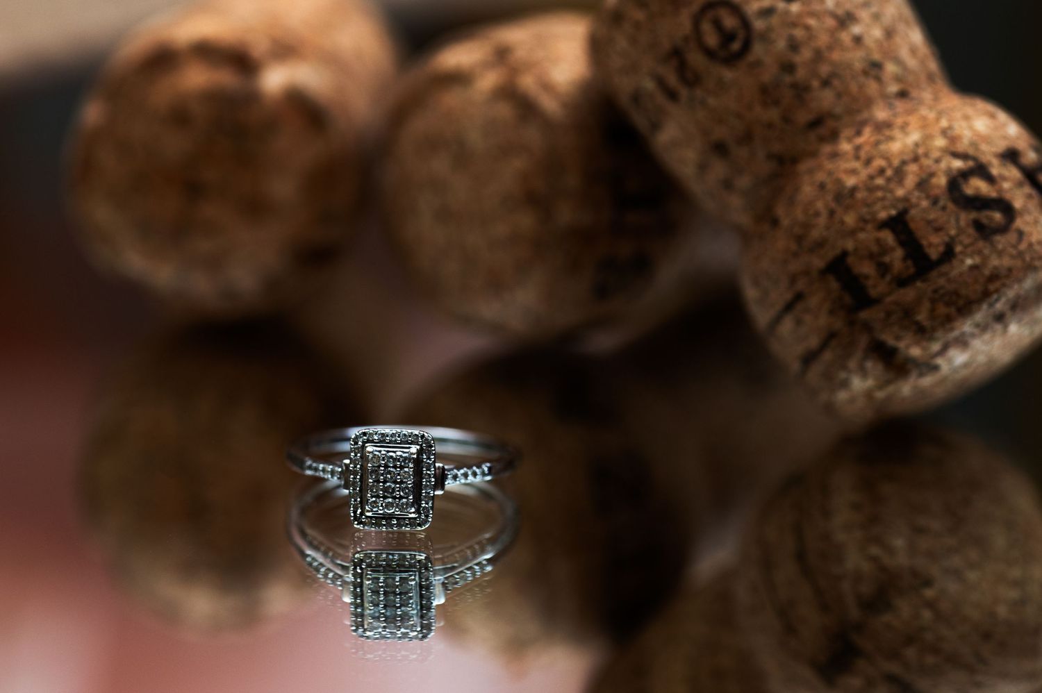 Macro shot of an elegant diamond engagement ring with intricate details.