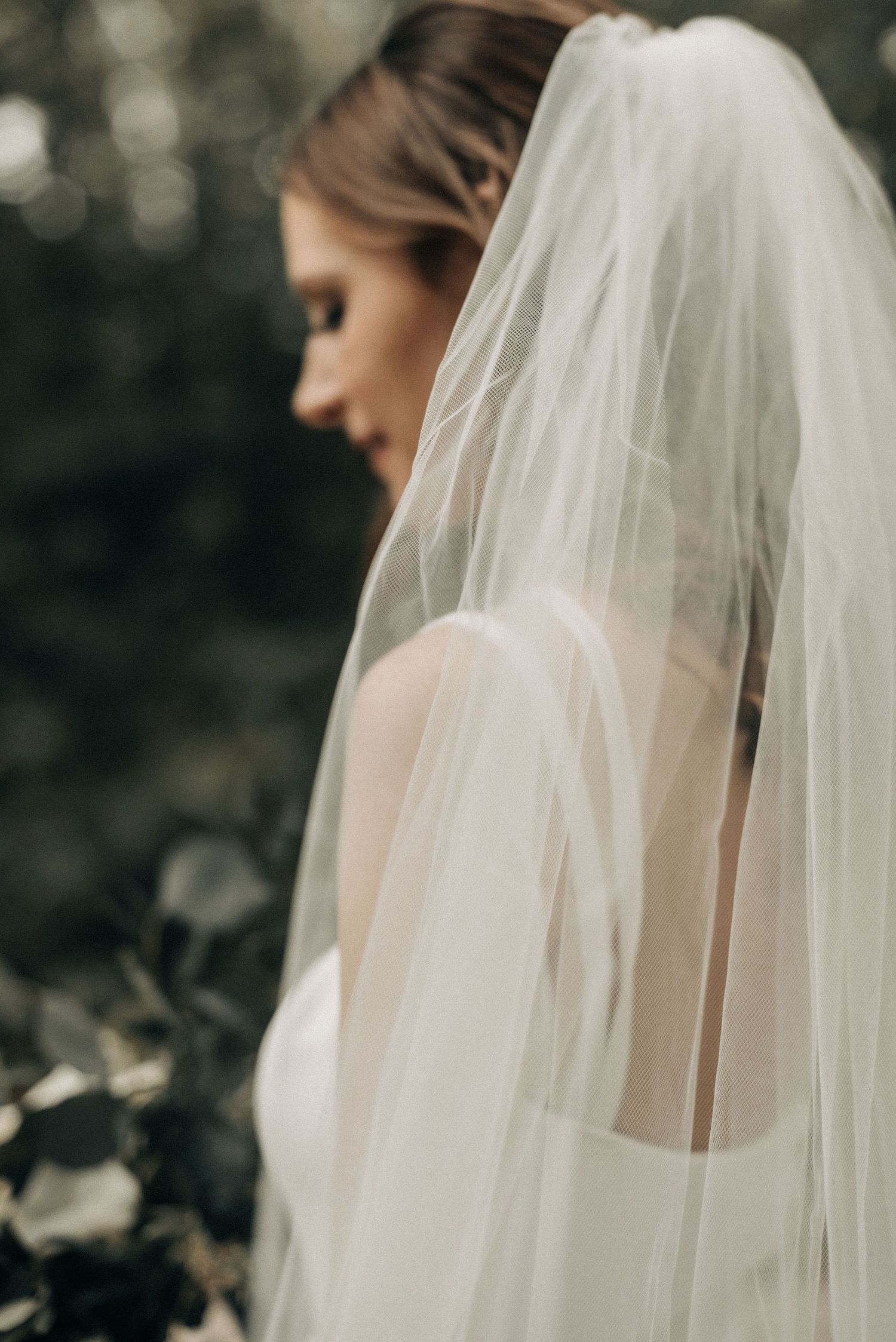 Elegant bridal veil flowing in soft natural light with ethereal bokeh background.