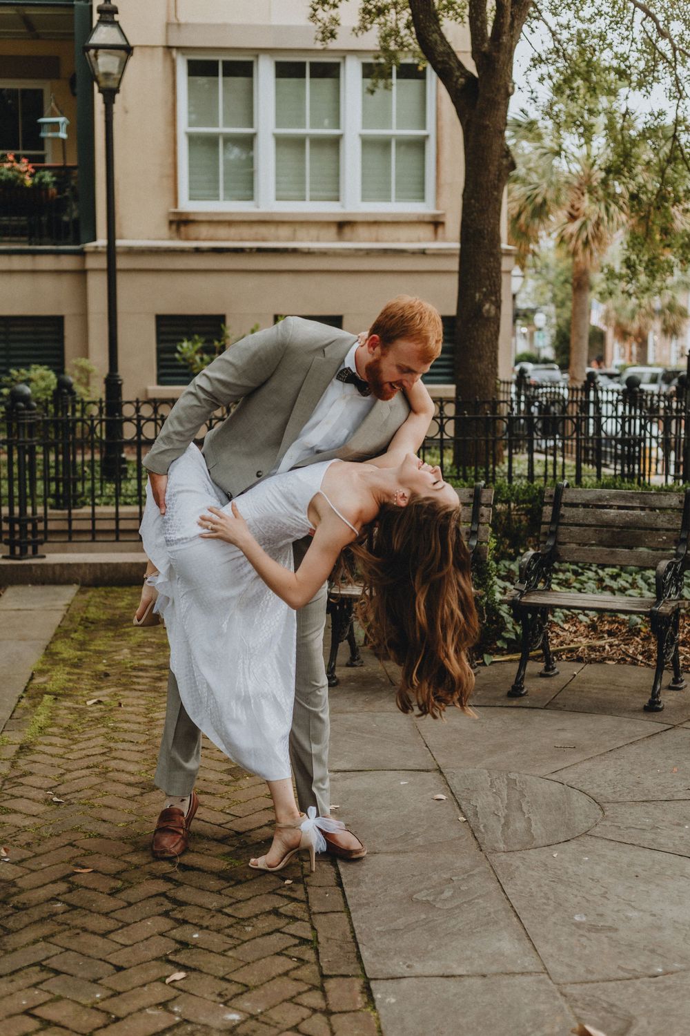 A man dramatically dipping his partner back at Waterfront Park in Charleston