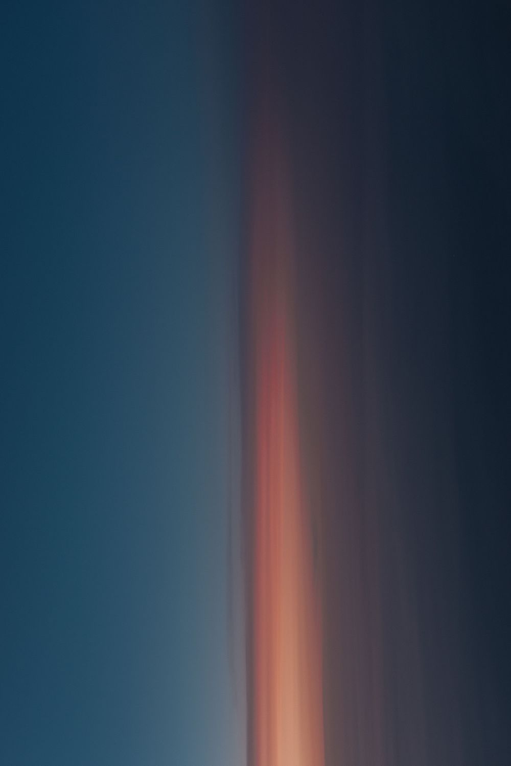 Gradient sky transitions from deep blue to orange in a minimalist sunset composition.
