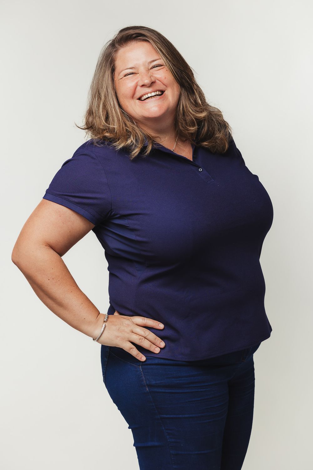 Portrait in navy blue polo shirt against white background.