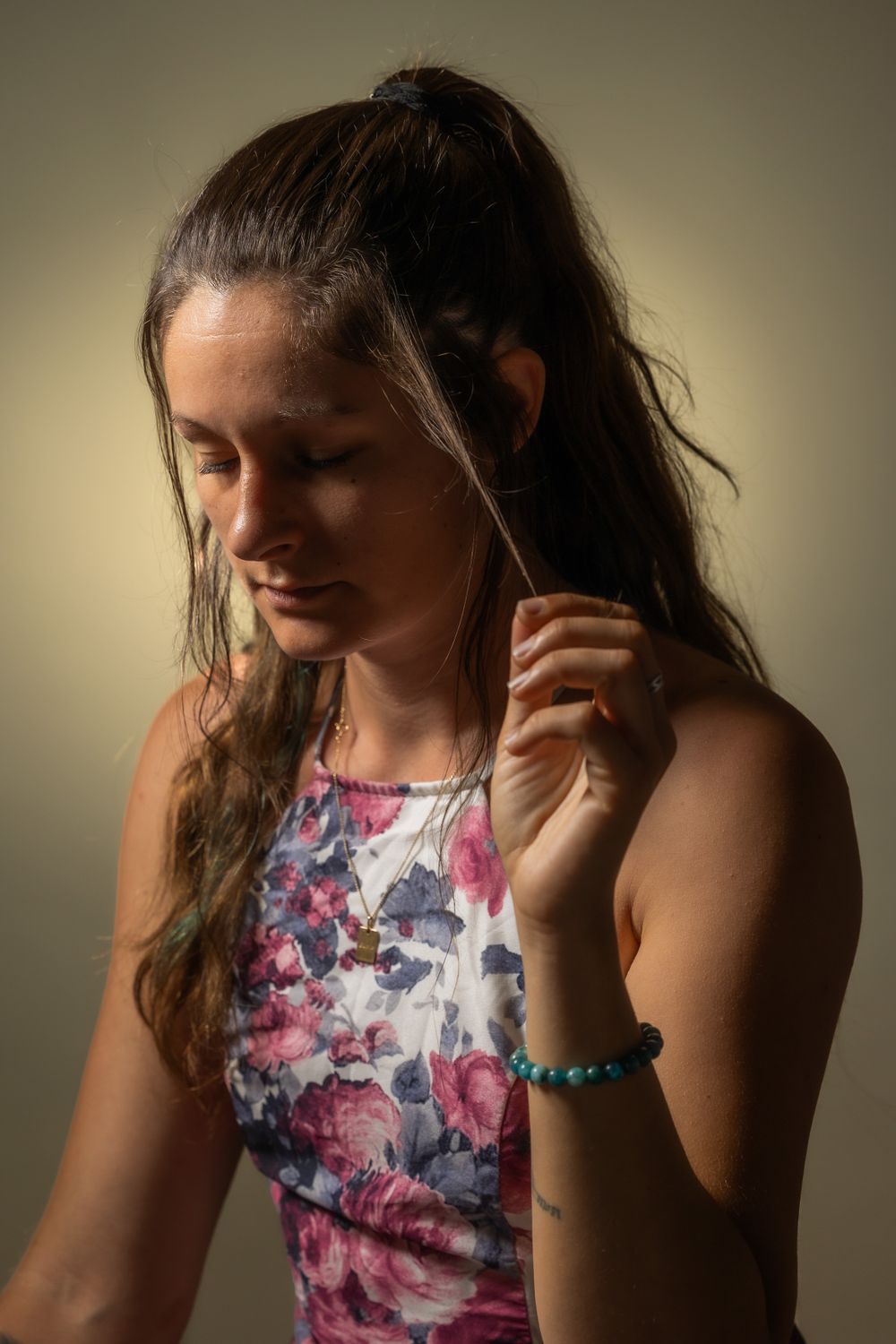 Artistic portrait series showing someone in a floral print top with long hair.