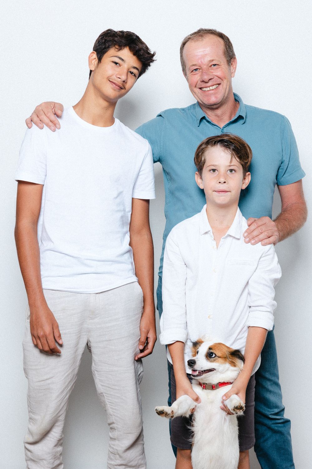Family photo series with a small dog in casual white and blue outfits against white background.