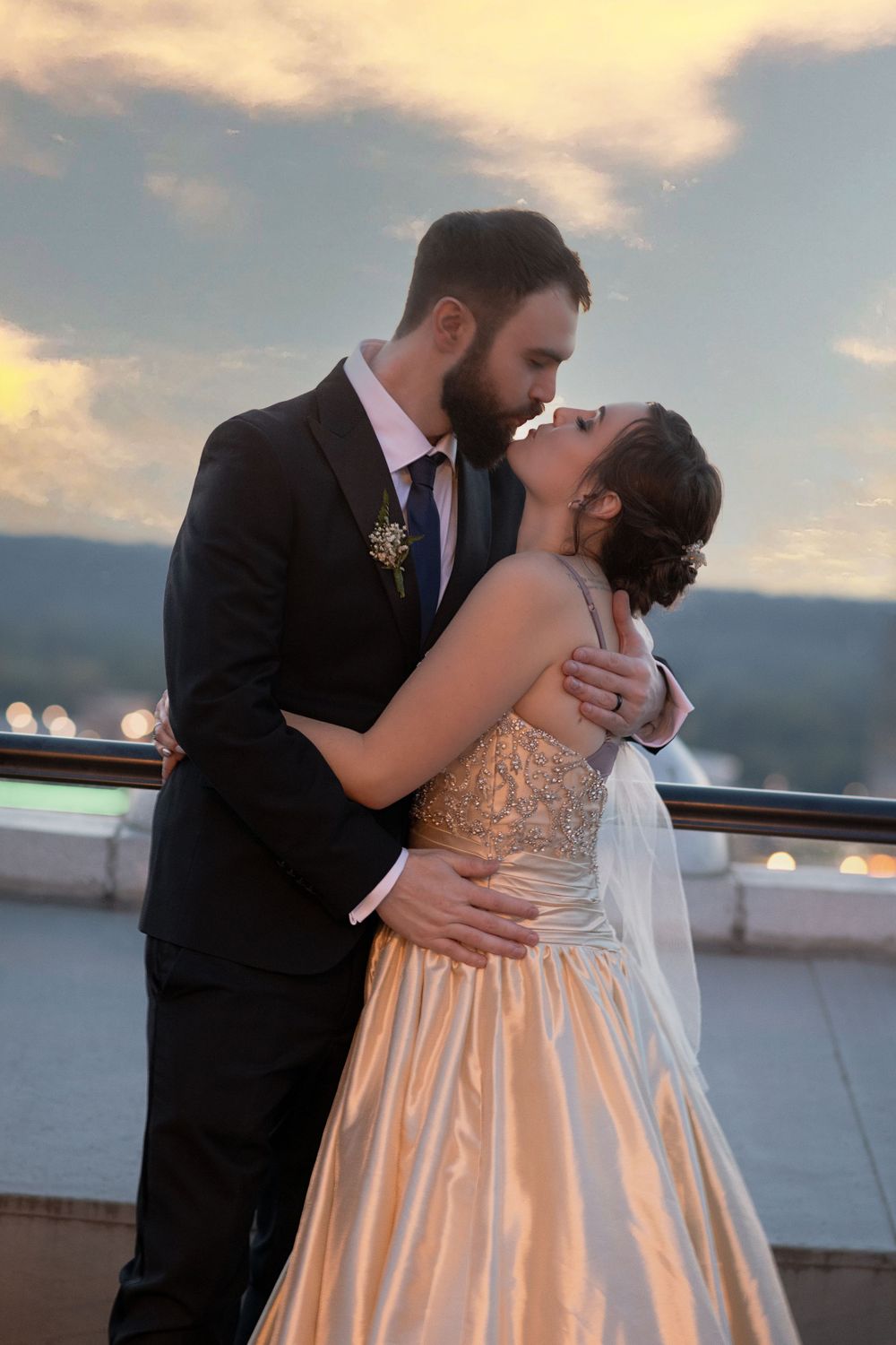 A romantic sunset wedding moment captured on an outdoor terrace with mountain views.
