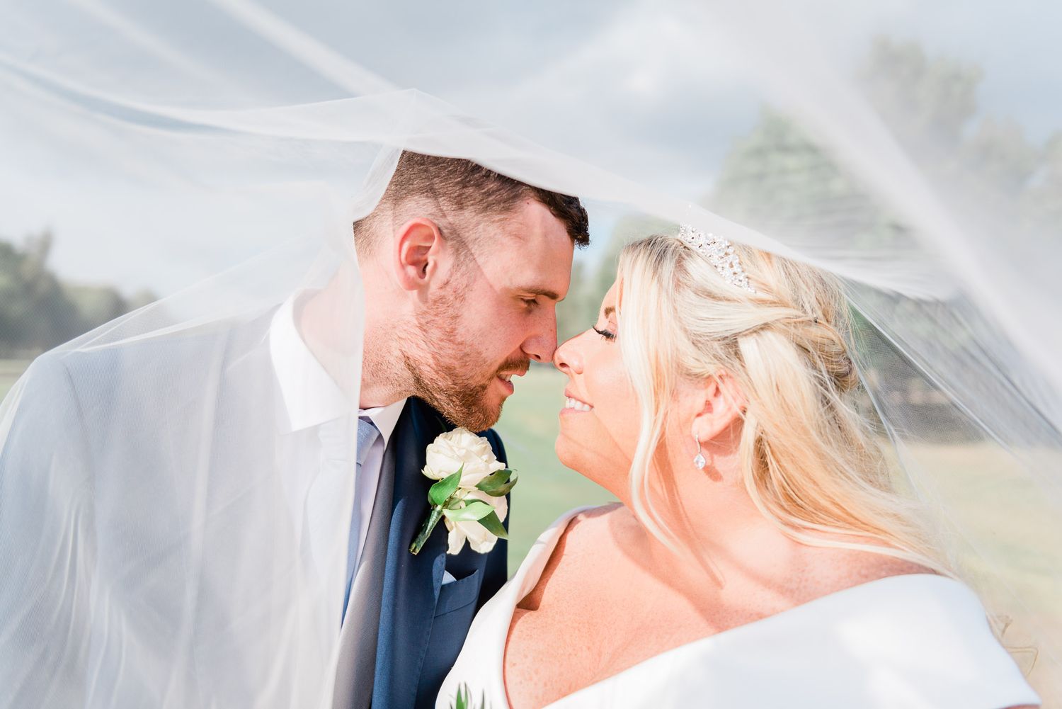 bride and groom look in to each others eyes under the veil
