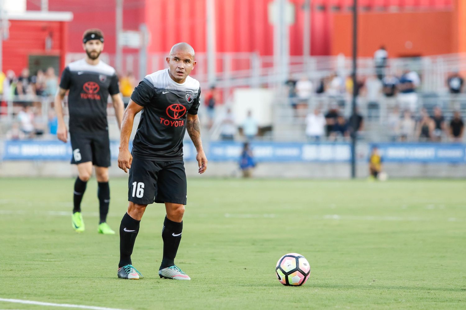 Soccer players positioning themselves on a field during gameplay.