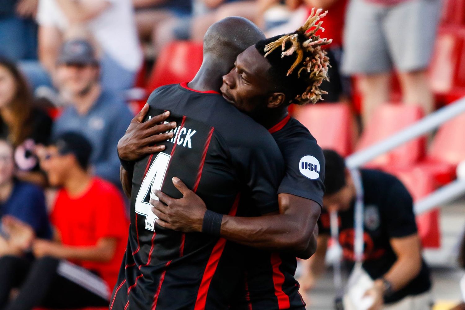 Soccer players celebrating with teammates during a match.