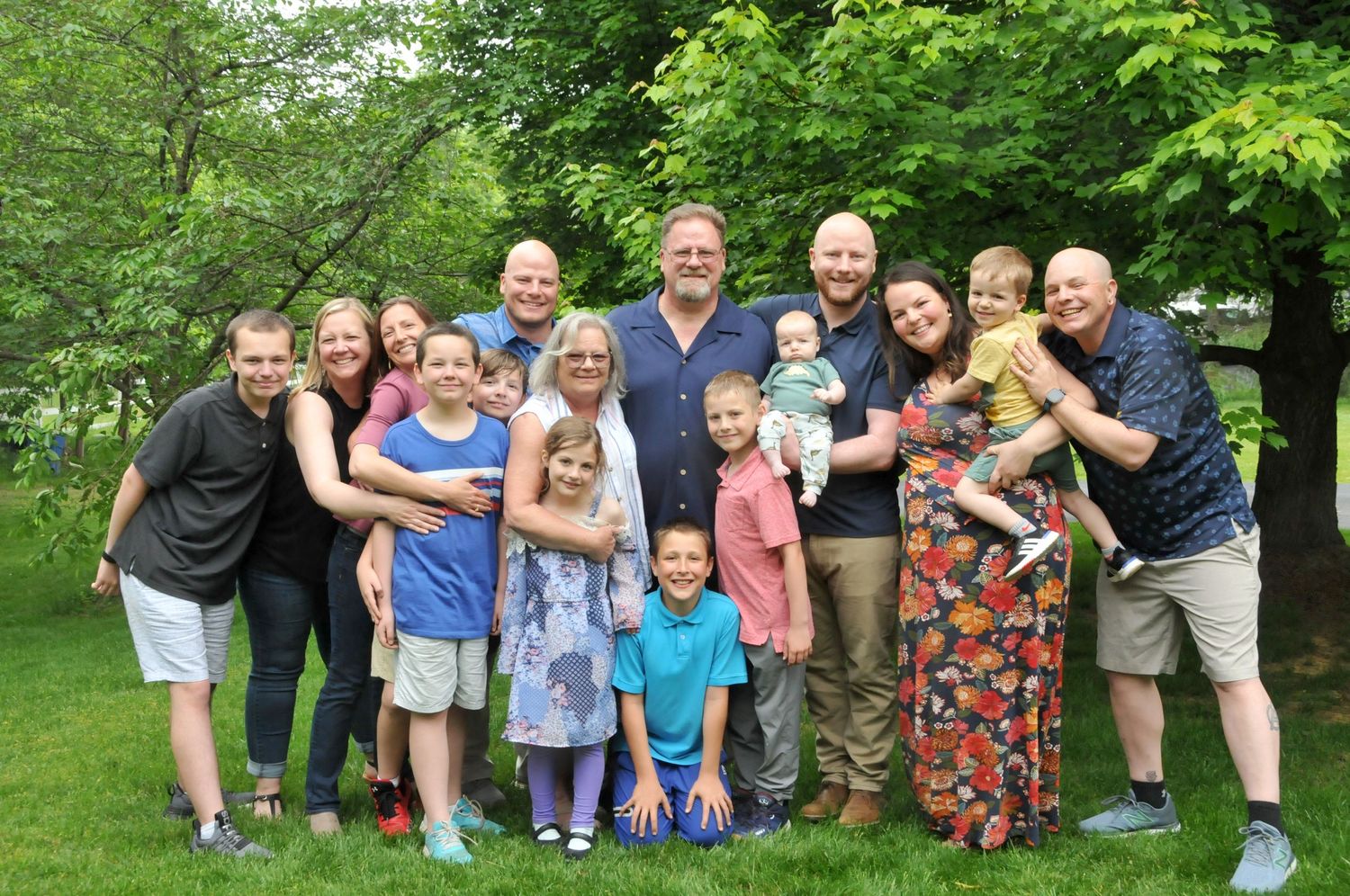 Outdoor photo of extended family hugging